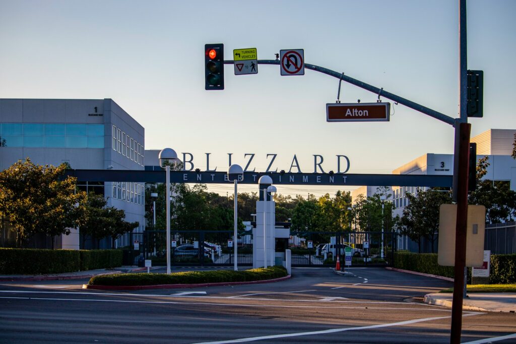 A street sign on a pole in front of a street light