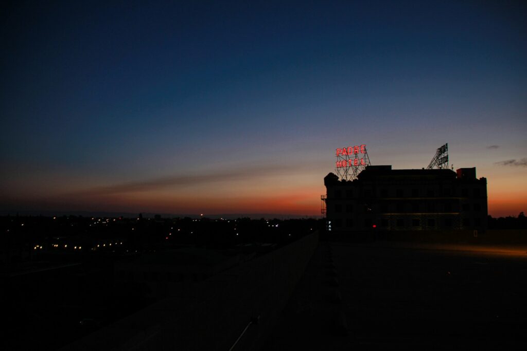 silhouette of the Padre Hotel building in Bakersfield CA under a cloudy sunset sky