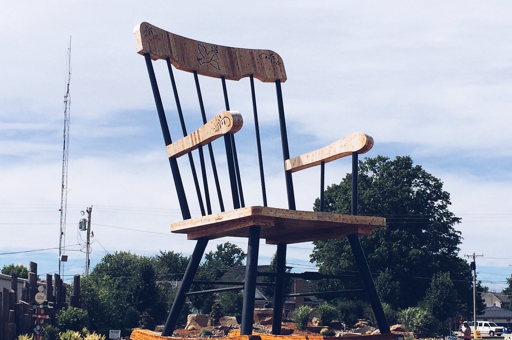 A building-sized rocking chair shown against a blue sky 