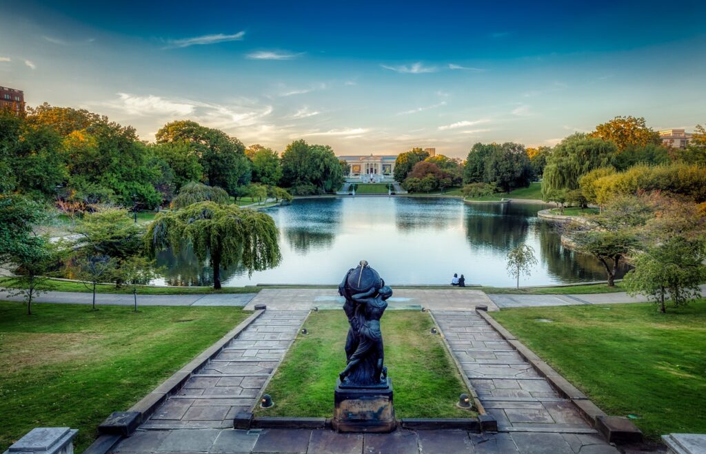 a museum building with a lake and trees