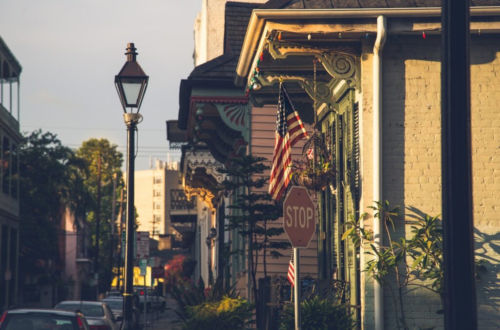 red and white stop sign against classic creole architecture